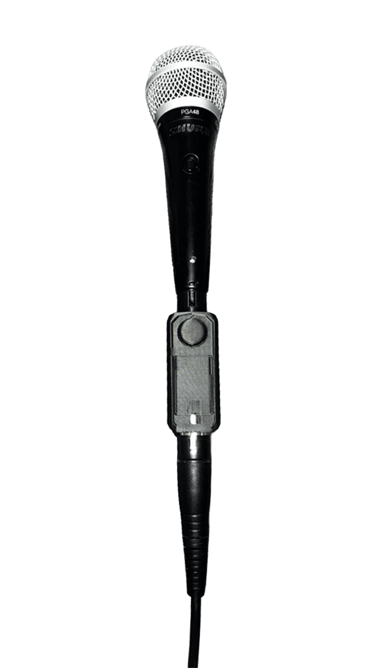 VOXCHAIN V1 mounted inline at the XLR base of a Shure handheld microphone.